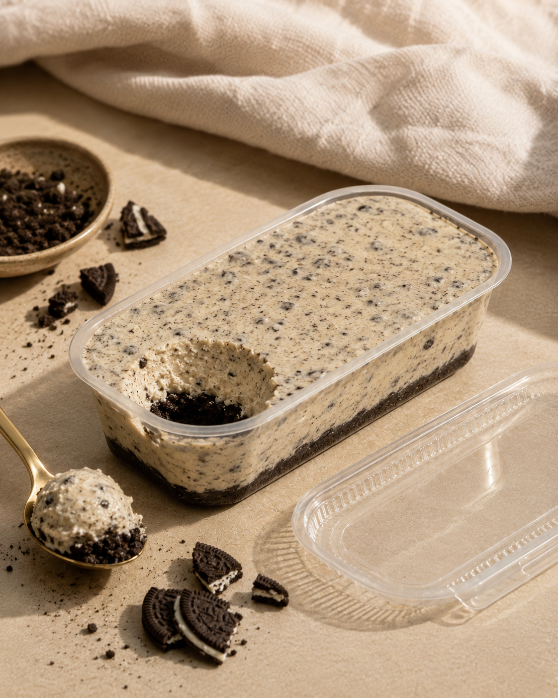 Cookies and cream high protein cheesecake dessert in a clear tub